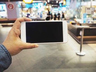 Smart phone on hand at shopping mall