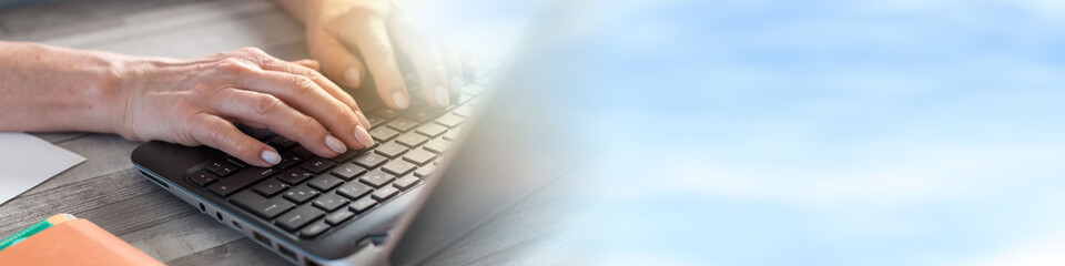 Female hands using a laptop, light effect