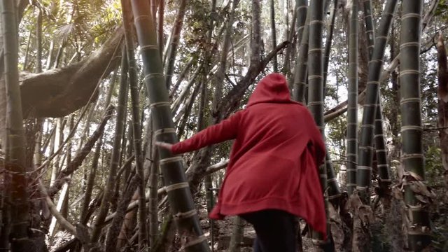 Woman runs through the bamboo