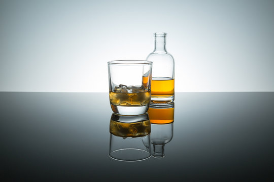 burbon whiskey on the rocks ice shapped like stars on reflective surface
