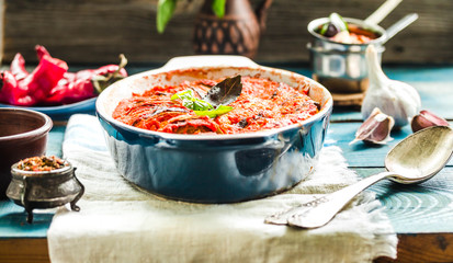 Ratatouille on rustic background, baked vegetables in tomato sauce with basil and paprika
