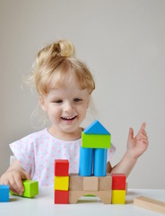 Caucasian Girl Playing with Wooden Colorful Cubes at Home Early Education Preparing for School Development
