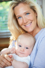Smiling mother holding baby