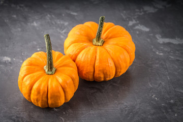 orange decorative pumpkins on a gray background
