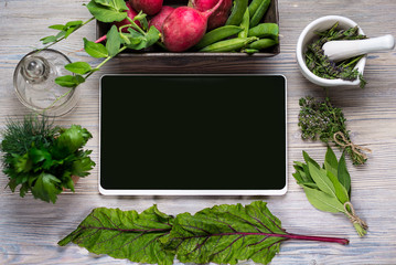 Empty Digital black tablet  for your text, on wood background