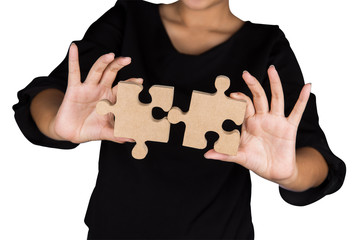 Business woman showing two jigsaw puzzle piece for business success, team work, business achievement isolated on white background. Business connecting concept.