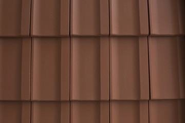 Red tiles of shingles on the roof