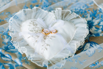 Heart-shaped pillow with chiffon lace and wedding gold rings