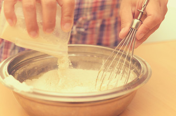 A woman kneads a homemade dough for pizza production.
