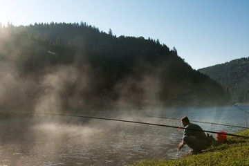 A man passionate about fishing, in the morning he washed his hands in the lake