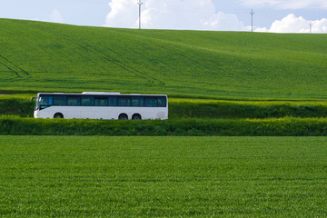 White Bus in countryside green road. © Premium_art