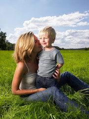 Fototapeta premium Mother and son playing in a field
