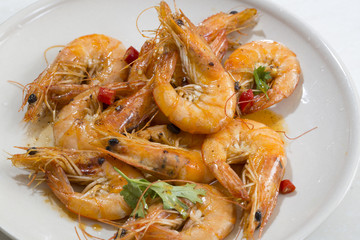 Seafood prawns closeup on a white dish.