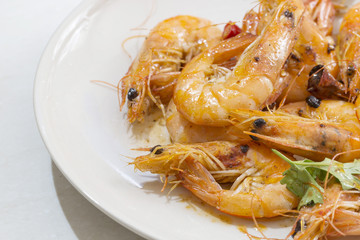 Seafood prawns closeup on a white dish.