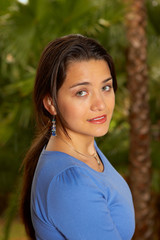 Young woman standing on balcony smiling