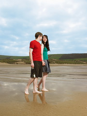 Young couple walking on beach