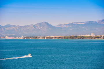 White yacht on mediterranean sea, Costa Dorada, Tarragona, Catalanya, Spain. Blue sky. Copy space for text.