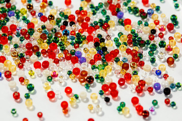 Colorful glass beads on white background, close up photo.