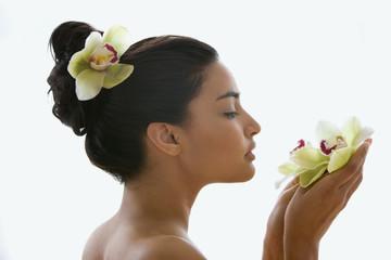 Young woman holding an orchid flower