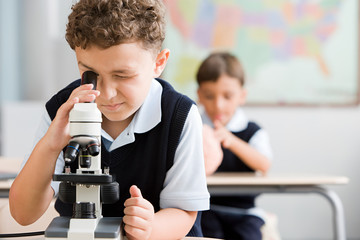 Schoolboy with microscope