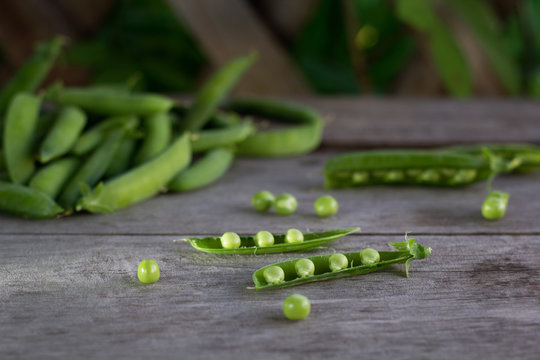 young juicy green peas on a wooden table