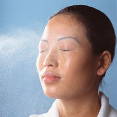 Water spraying on womans face