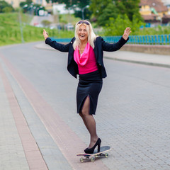 Senior business woman having fun on a skateboard outdoors. The concept of moving forward.