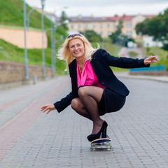 Senior business woman having fun on a skateboard outdoors. The concept of moving forward.