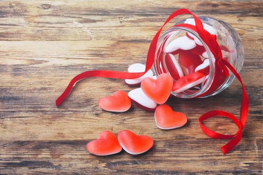 Marmalade candy shape heart in glass jar with ribbon