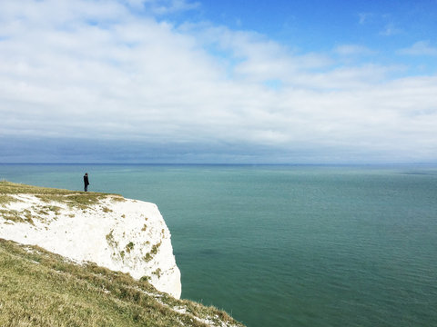 Girl standing on the white cliffs of Dover