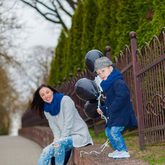 Portrait of fashionable baby boy and his gorgeous mother. little boy hugs his mother emotionally.