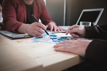 Business team hands at working with financial plan and a tablet on office desk