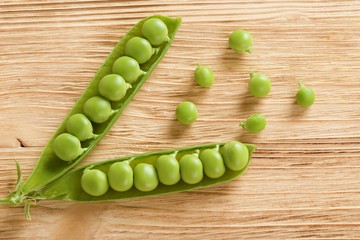 fresh peas on wooden background