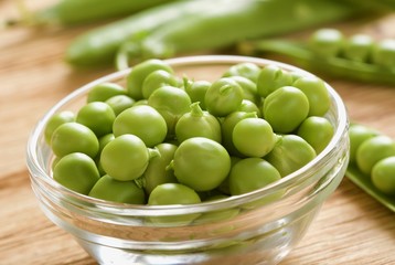fresh peas on wooden background