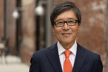 Asian businessman face portrait smiling happy