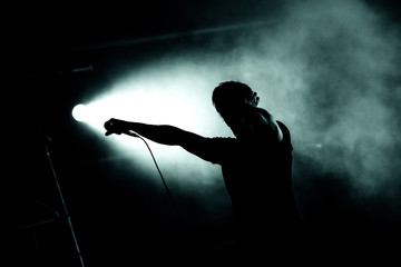 Silhouette of a singer holding microphone
