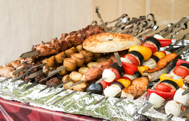 Meat, fish and vegetable kebab on a metal skewers