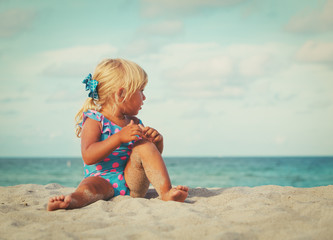 cute little girl play on beach