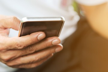 A man using smartphone in his hand.