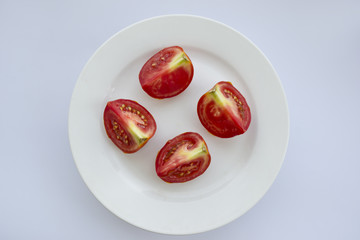 Slices of tomato on white background