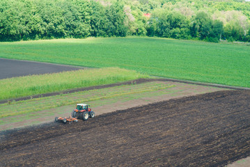 Fototapeta premium Tractor plowing field