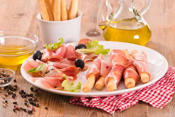 Grissini breadsticks with ham. 
