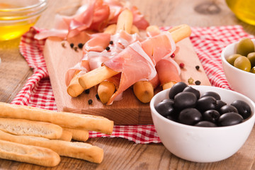 Grissini breadsticks with ham. 