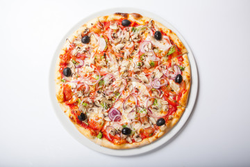 Pizza with onion and ham, cheese and tomato. White background