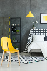 Creative dark bedroom with yellow lamp