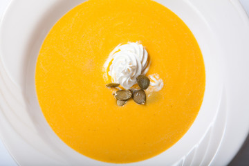 Pumpkin Soup with whipped cream and pumpkin seeds
