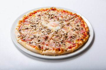 Italy pizza with egg yolk ham mushrooms on a white background