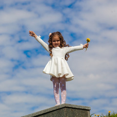 little girl in the clouds. little girl walks among the clouds. dreamy and fantasy concept. Little girl shows up. The girl looks up in surprise