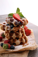 Traditional belgian waffles with fresh fruit and powder sugar