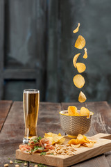Beer glass and potato chips, pistachios isolated on a white